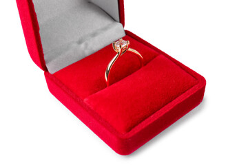 Box with golden engagement ring on white background, closeup