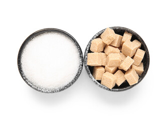 Bowls with different types of sugar on white background