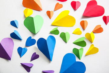 Colorful paper hearts on grey background. LGBT concept