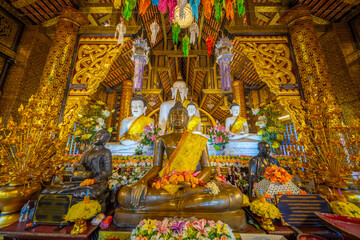 Beautiful Wat Buddhist temples in Chiangmai Chiang mai Thailand. Decorated in beautiful ornate colours of red and Gold and Blue. Lovely sunset