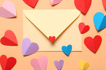 Composition with envelope and paper hearts on color background. Valentines Day celebration