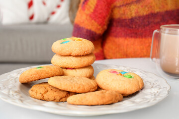 Plate with tasty cookies on table at home