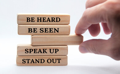 Be heard, be seen, speak up, stand out text on wooden block. Business concept