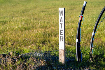 Sign post for underground water utilities on a new residential community construction site
