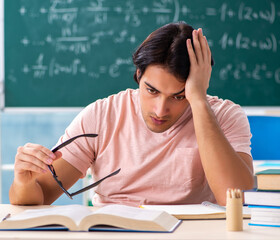 Young male student in the classroom