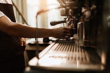 Selective focus, Hand Barista making coffee with espresso coffee machine in coffee shop. Closeup,...