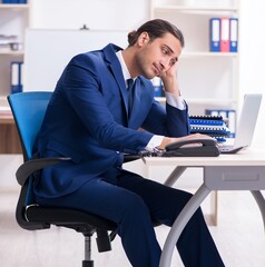 Young male businessman working in the office