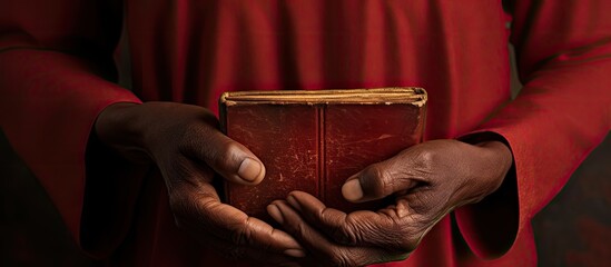 Symbolic of faith in South Africa, a hand holds a well-used prayer book during a Methodist church service. - obrazy, fototapety, plakaty