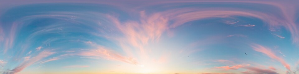 Sunset sky panorama with bright glowing pink Cirrus clouds. Seamless hdr 360 panorama in spherical...