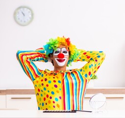 Male clown preparing for perfomance at home