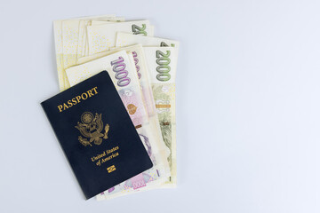 Fototapeta premium Czech currency koruna money bills and U.S. Passport with white background.