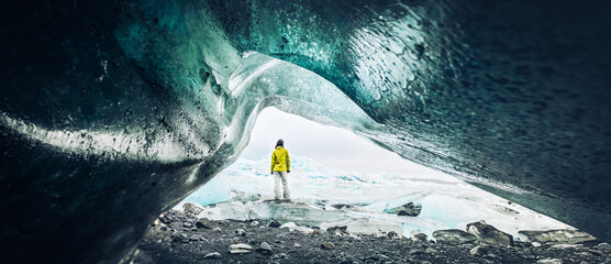 Panoramic viewpoint tourist by Fjallsjökull glacier in Iceland from inside glacier cave. Explore sightseeing Iceland spectacular hidden gems. Traveler hands up enjoy travel concept - obrazy, fototapety, plakaty