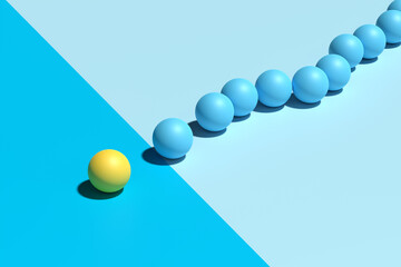 Yellow sphere sits apart from a group of blue spheres.