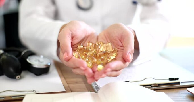 Doctor holding dietary supplements omega3 amino acids in his hands closeup 4k movie slow motion. Homeopathy and evidence-based medicine concept