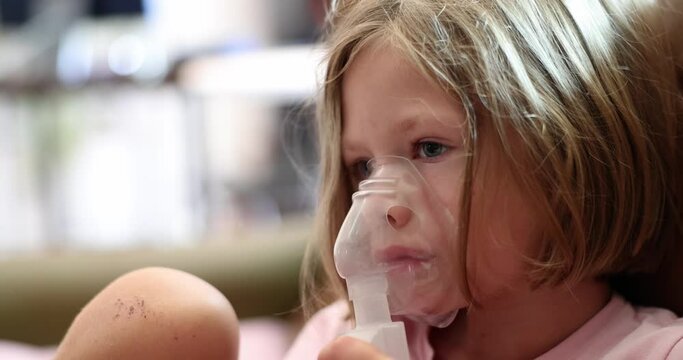 Little sick girl making inhalation with hormonal drug for laryngitis 4k movie slow motion. Pneumonia treatment concept