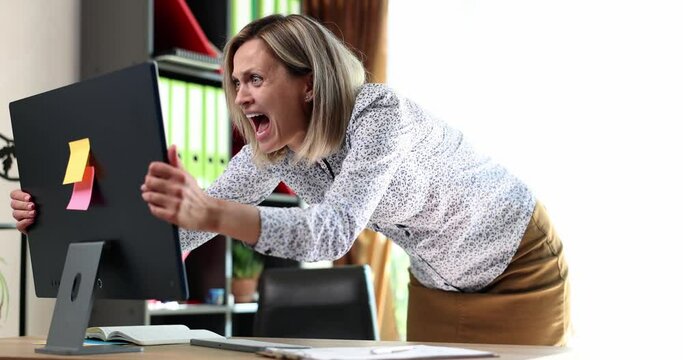Shocked business woman looking at information on computer screen and screaming 4k movie slow motion. Difficulties of working remotely concept