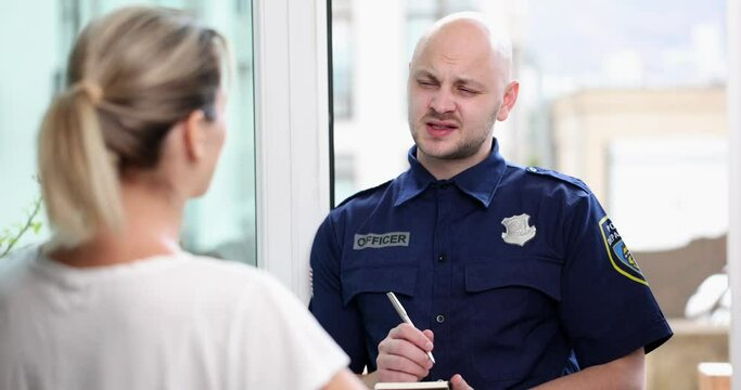 Male police officer interrogating woman at home 4k movie slow motion. Police emergency concept