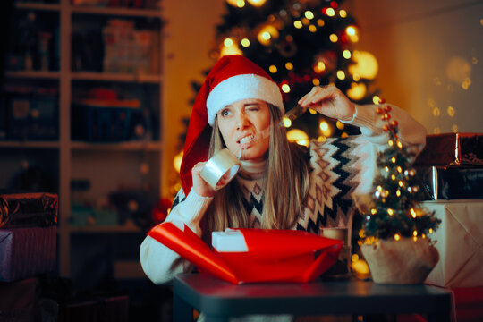 Woman Using Teeth to Tear a Scotch Tape Packing Gifts. Girl endangering her teeth enamel engaging in bad habits 

