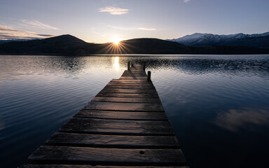 New Zealand lake at sunset near Queenstown with jetty