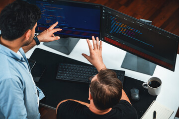 IT developers discussing online software development information on pc screen, creating program...