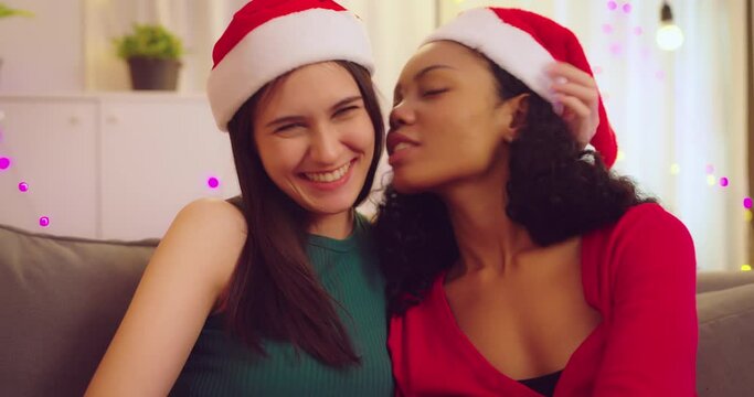 Couple lesbian have Christmas party in living room. They kissing each other with happy expression at home.