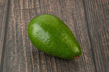 Ripe green avocado over background