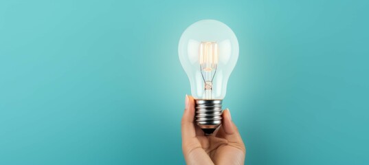 A hand holding light bulb on green tosca background. Creative idea brainstorming concept. Generative AI technology.		
