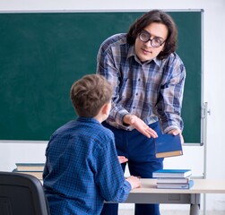 Funny male teacher and boy in the classroom