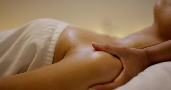 Relax, skincare and woman with neck massage at spa in zen, physical therapy on bed with candles at resort. Calm female person sleeping in rest, body care or break for health and wellness at salon.