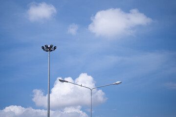 Electrical poles, sports line poles with small birds perched on a bright sky background