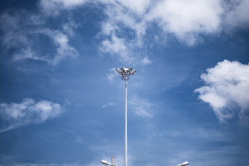 Electrical poles, spotlight poles on the background of the blue sky