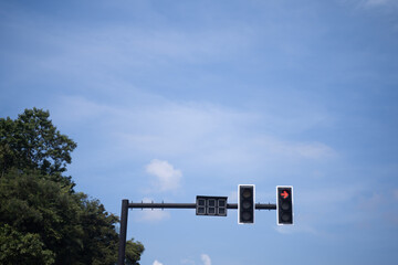 Traffic lights on the bright blue sky background