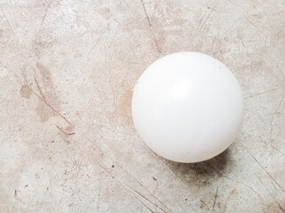 Small white plastic ball on concrete table