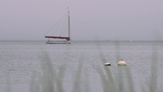 Red Boat in Nantucket Harbor Gray, Rainy Day