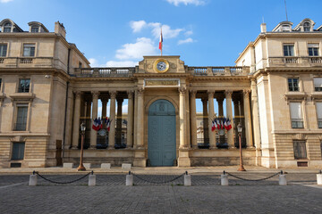 Back entrance of the French National Assembly (Palais Bourbon) with French flags fluttering in the...