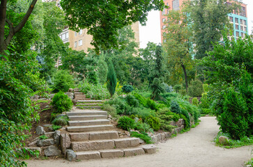 Stones for an alpine hill, landscape design of a personal plot. Plants and stones in the background of the landscape.