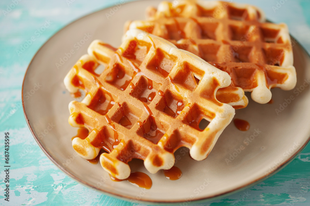 Wall mural Belgian waffles on a plate. Homemade simple pastries