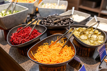Colorful Salad Bar with Assorted Fresh Vegetables and Toppings in hotel