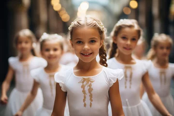 Zelfklevend Fotobehang Portrait of adorable little ballerinas, in white costumes, with group of other girls, in theater or concert hall before performance in dance suits © KatyaPulina
