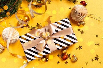 Christmas present box, Gifts and festive decorations on yellow background. Christmas New Year background.