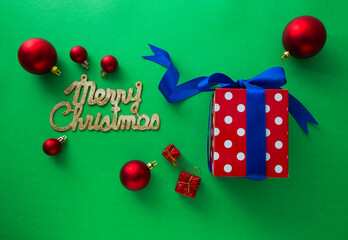Gift boxes and Christmas decorations on green background