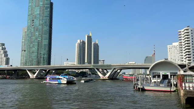 Bangkok, Thailand - January 28, 2023: View of King Taksin the Great Bridge and a passing boat