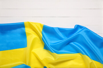 Flag of Sweden on white wooden background, top view. Space for text
