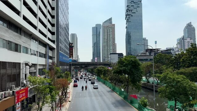 Bangkok, Thailand - January 28, 2023: View of the highway, Silom Plaza and sky train passing by
