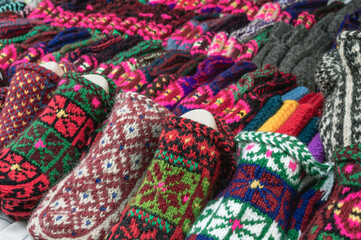 Multicolored wool knitted handmade mittens for the cold season. Things made of natural yarn. Winter...
