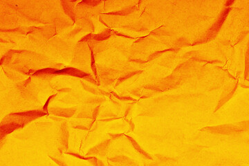 Yellow crumpled paper texture. Grunge old parchment background. Bright orange backdrop. Stained...