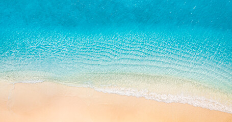 Relaxing aerial beach scene, summer vacation holiday template banner. Waves surf with amazing blue ocean lagoon, sea shore, coastline. Perfect aerial drone top view. Peaceful bright beach, seaside