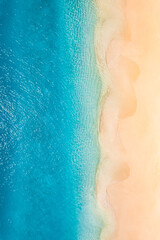 Summer seascape beautiful waves, blue sea water in sunny day. Top view from drone. Sea aerial view, amazing tropical nature background. Inspirational bright sea with waves splash crash and beach sand - obrazy, fototapety, plakaty