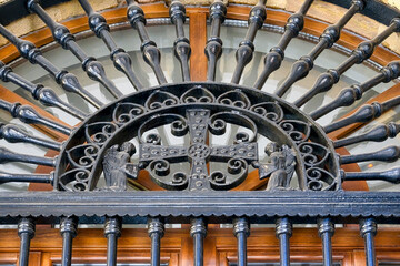 Ancient decorative metalwork with arch and cross in Oviedo, Spain
