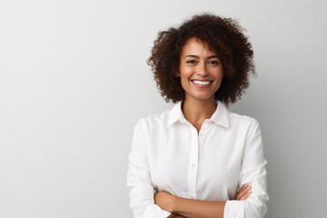 Portrait of a happy young african american businesswoman standing against white background